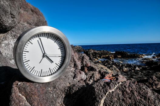 Time Concept Alarm Clock on the Volcanic Rocks