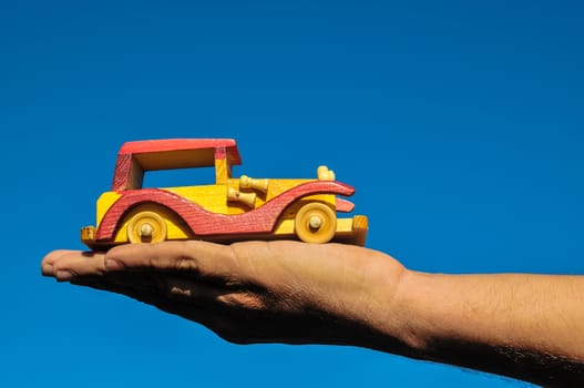 Transportation Concept Wooden Toy Car on the Hand