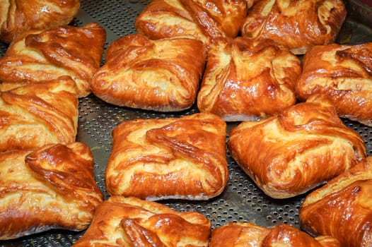 tray of hot crunchy glossy baked wrap buns with stuffing