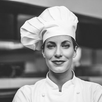 Smiling chef looking at camera in a commercial kitchen
