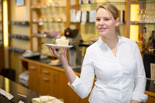 waitress presenting cup of coffee or tea on tray