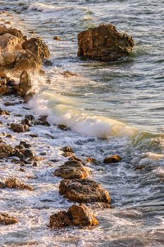 Sea tide in rays of sunset on Tarhankut, Black sea, Crimea, Ukraine