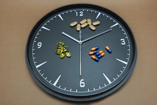 concept for Healthcare And Medicine, a clock marks the time of taking medicines