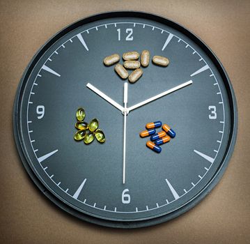 concept for Healthcare And Medicine, a clock marks the time of taking medicines