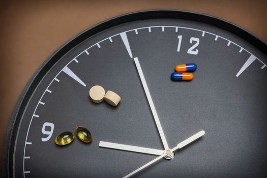 concept for Healthcare And Medicine, a clock marks the time of taking medicines