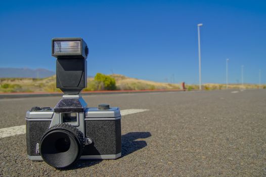 Street Photography Concept Vintage Camera on the Asphalt