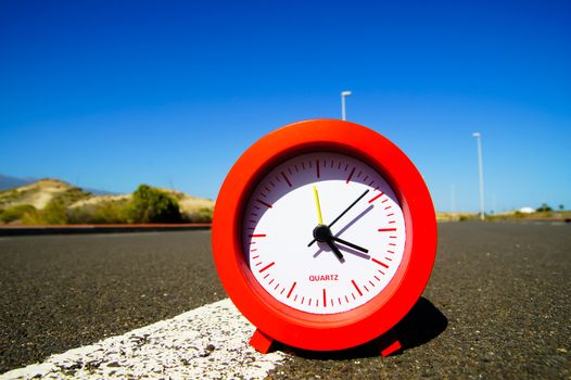 Time Concept Alarm Clock on the Asphalt Street