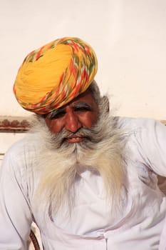 Indian man sitting at Mehrangarh Fort, Jodhpur, Rajasthan, India