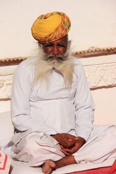 Indian man sitting at Mehrangarh Fort, Jodhpur, Rajasthan, India