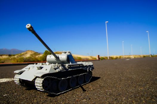 Modern War Concept Model Tank in the Middle of an Asphalt Road