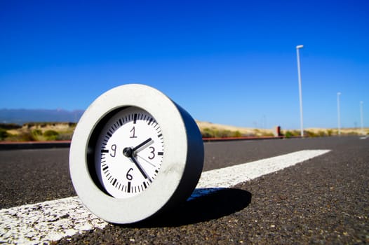 Time Concept Alarm Clock on the Asphalt Street