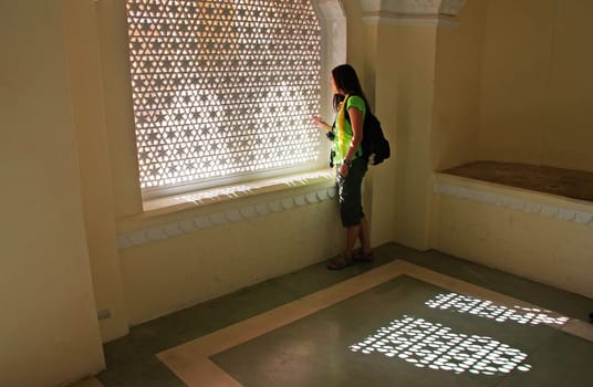 Young woman standing by the window, Mehrangarh Fort, Jodhpur, Rajasthan, India