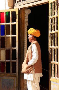 Indian man standing by the doorway at Mehrangarh Fort, Jodhpur, Rajasthan, India
