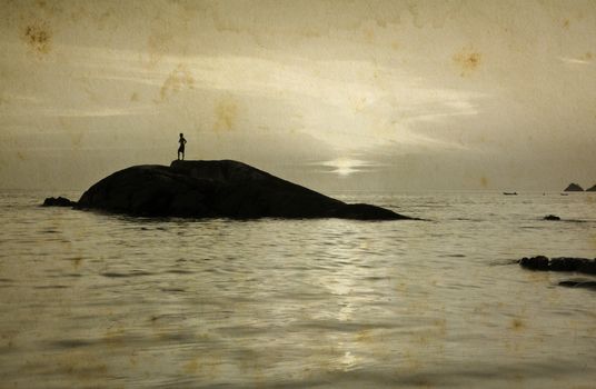 Lonely Man standing on small stone during sunset, grunge style