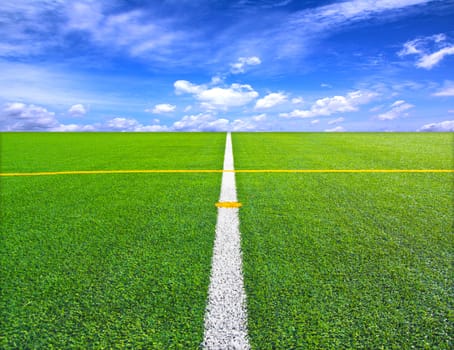 Soccer or football field over blue sky background