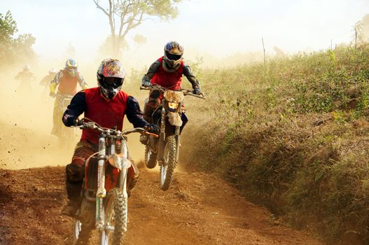 BAO LOC, VIET BAM, DEC 23: The motorcycle race hole on December 23, 2013  at Dambri waterfall, Bao Loc, Viet Nam, motorcyclist try to speed up goal red soil way indistinct dust