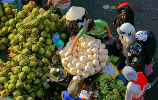 DA LAT, VIET NAM- FEBRUARY 8: People sell and buy coconut at farmers market in  Dalat, VietNam- February 8, 2013