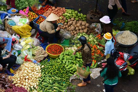 DA LAT, VIET NAM- FEBRUARY 8.People sell and buy vegetables at farmers market in  Dalat, Viet Nam- February 8, 2013