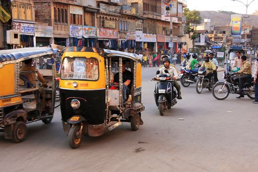 People riding tuk-tuks and motobikes at Sadar Market, Jodhpur, Rajasthan, India