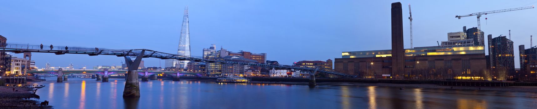 A panoramic view of London taking in the sights including the River Thames, Tate Modern, the Shard, Millennium Bridge, Shakespeare's Gobe Theatre, Blackfriars Bridge and Tower Bridge in the distance.