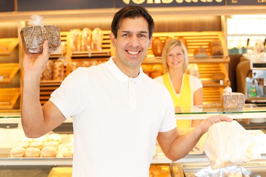 Happy customer just bought bread in bakery