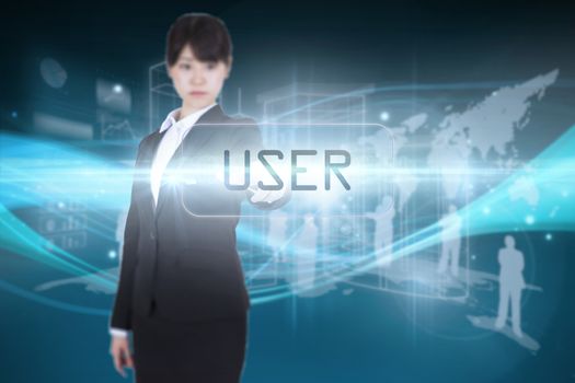 The word user and focused businesswoman pointing against abstract glowing black background