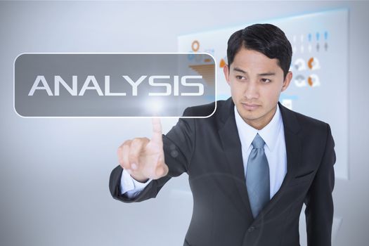 The word analysis and unsmiling asian businessman pointing against technology interface