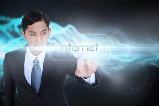 The word internet and unsmiling asian businessman pointing against abstract blue glowing black background