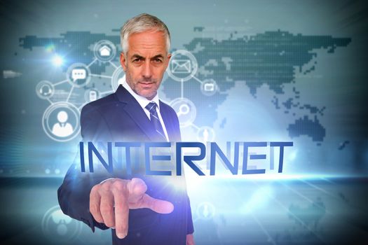 The word internet and businessman pointing against futuristic technology interface