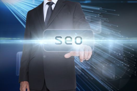The word seo and businessman pointing against abstract technology background