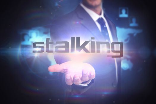 The word stalking and businessman presenting against futuristic technology interface