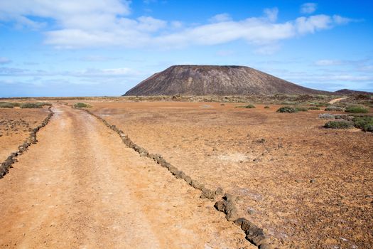 Trail and volcano La Caldera on the small island of Los Lobos, near Fuerteventura, in the Canary Islands, Spain.