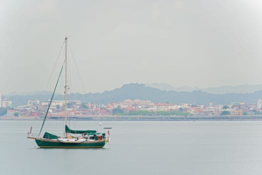 Sail boat and Casco Viejo in Panama City on the background on January 2, 2014.