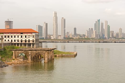 Old Panama houses at Casco Viejo, and  Panama City skyscrapers on the background on a sunny day onJanuary 2, 2014.