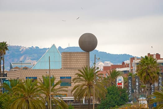 Barcelona, Spain - January 25, 2014: Detail of the Port Olimpic  Village in Barcelona with the big sphere sculpture designed by the famous architect Frank Gehry and erected in 1992. Spain. 