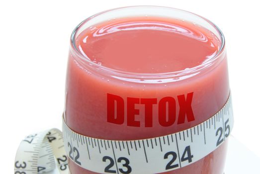 Measuring tape around a glass with a nutritious fruit smoothie