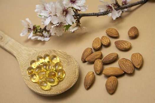 Almond oil in capsules isolated on brown background