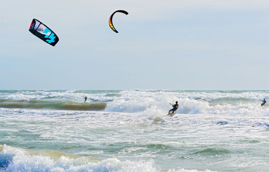 Barcelona, Spain - February 8, 2014: People are kite surfing on a sunny winter day in beaches in Barcelona on February  8, 2014