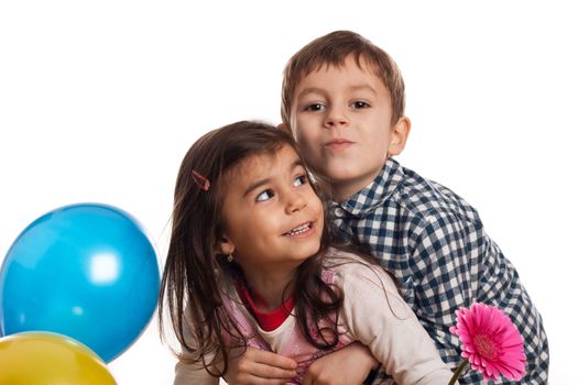 boy hugging girl with flower and balloons on white background