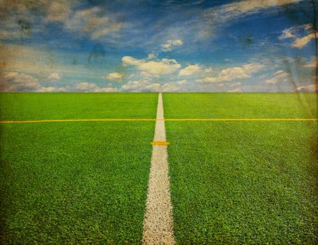 Soccer field with blue sky in grunge style 