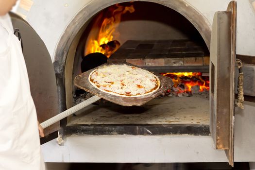 Pizza baking in the fire wood oven 