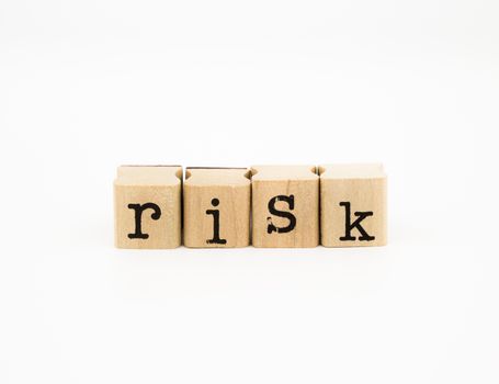 closeup risk wording isolate on white background, investment and insurance concept and idea.