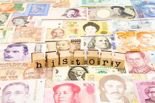 closeup history wording stack on banknotes, world currency, business and education concept and idea