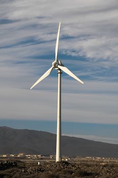 Eletric Power Generator Wind Turbine over a Cloudy Sky