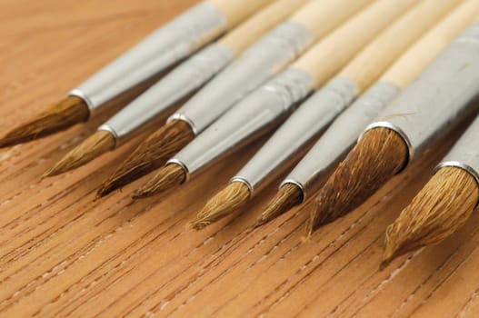 New Wooden Different Paintbrush Set Texture over a Colored Background