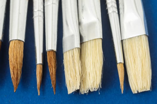 New Wooden Different Paintbrush Set Texture over a Colored Background