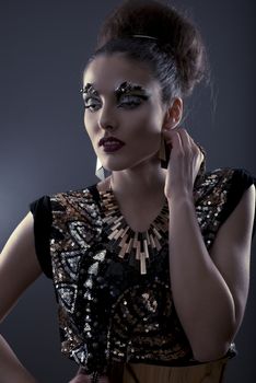 High fashion glamour model with gold dress & make up