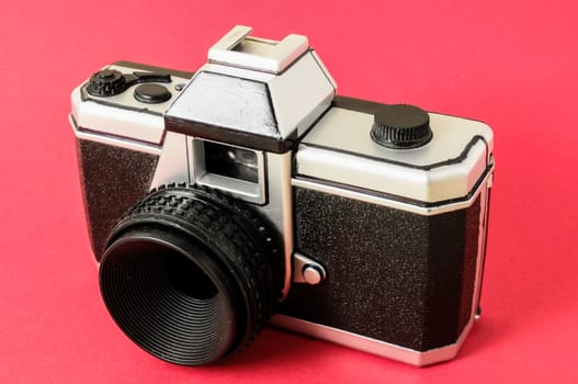 Classic 35mm Plastic Toy Photo Camera on a Colored Background