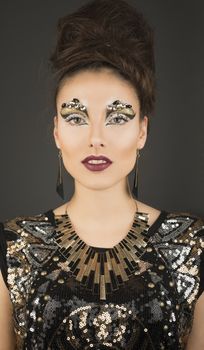 High fashion glamour model with gold dress & make up