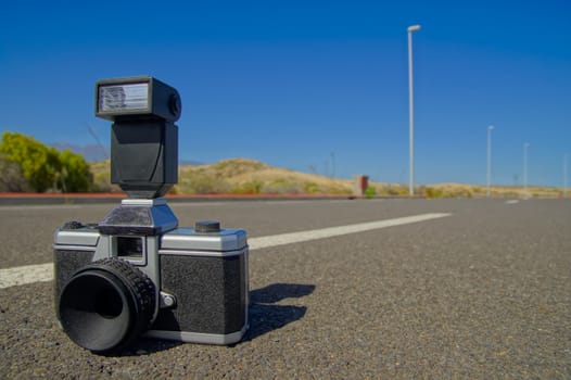 Street Photography Concept Vintage Camera on the Asphalt